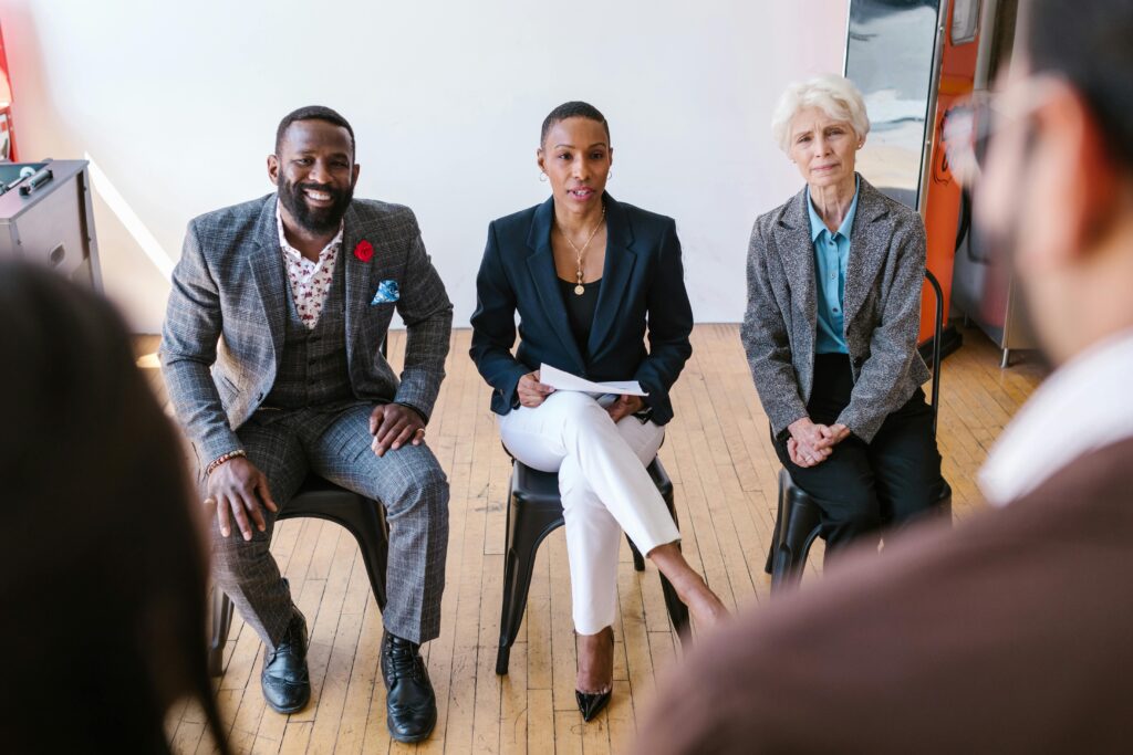 pexels-photo-7414022-7414022 A diverse group of professionals in a meeting, attentively listening and engaged.