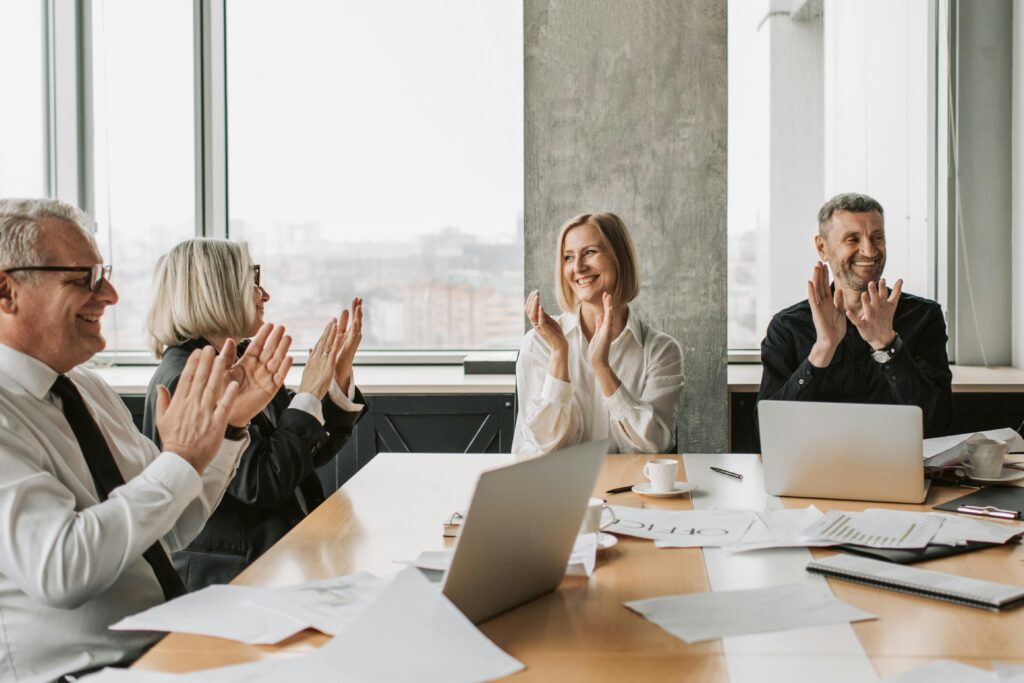pexels-photo-7434025-7434025 Business professionals clapping in a conference room, creating a lively and positive work environment.