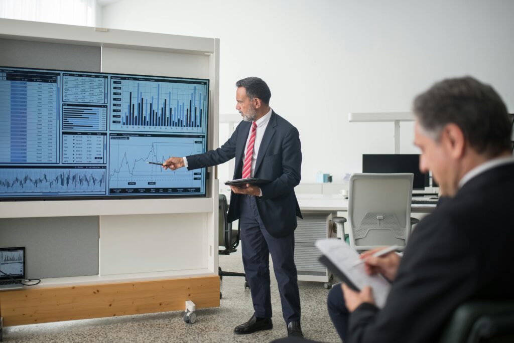 pexels-photo-8353800-8353800 Professional conducts data analysis presentation in a modern office setting.